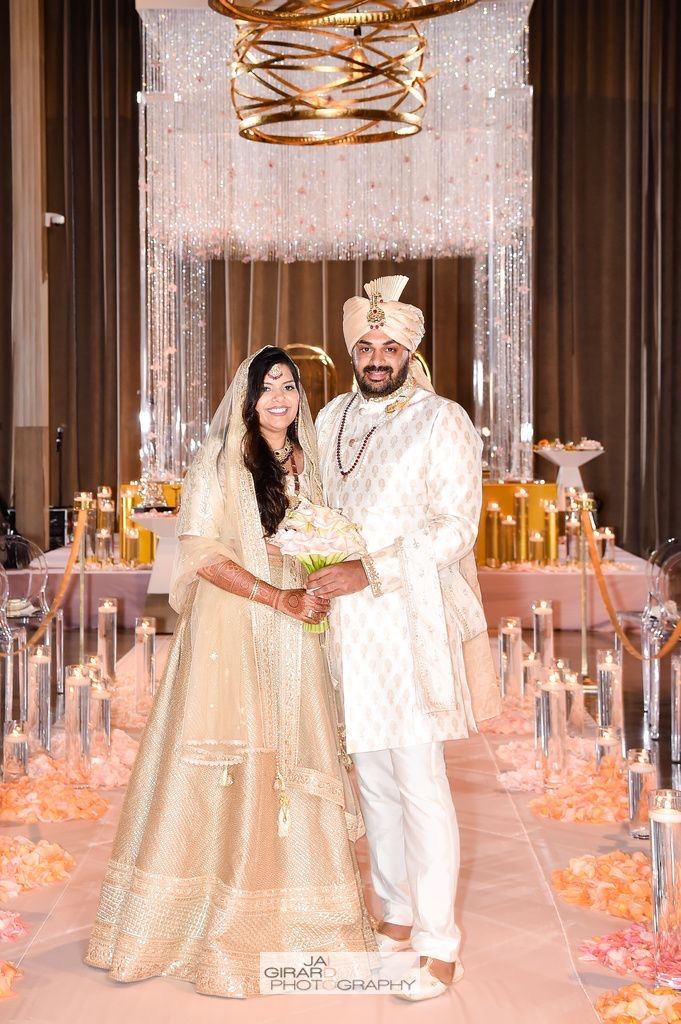 Bride and groom in coordinated ivory and gold wedding attire