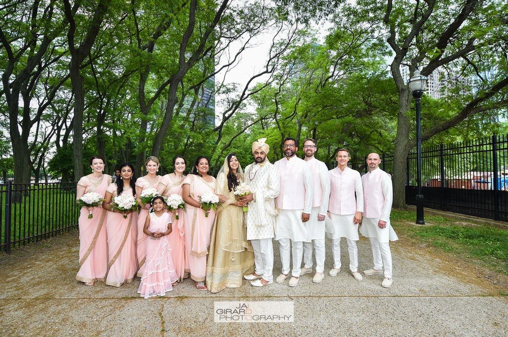Full bridal party in coordinated blush and ivory outfits