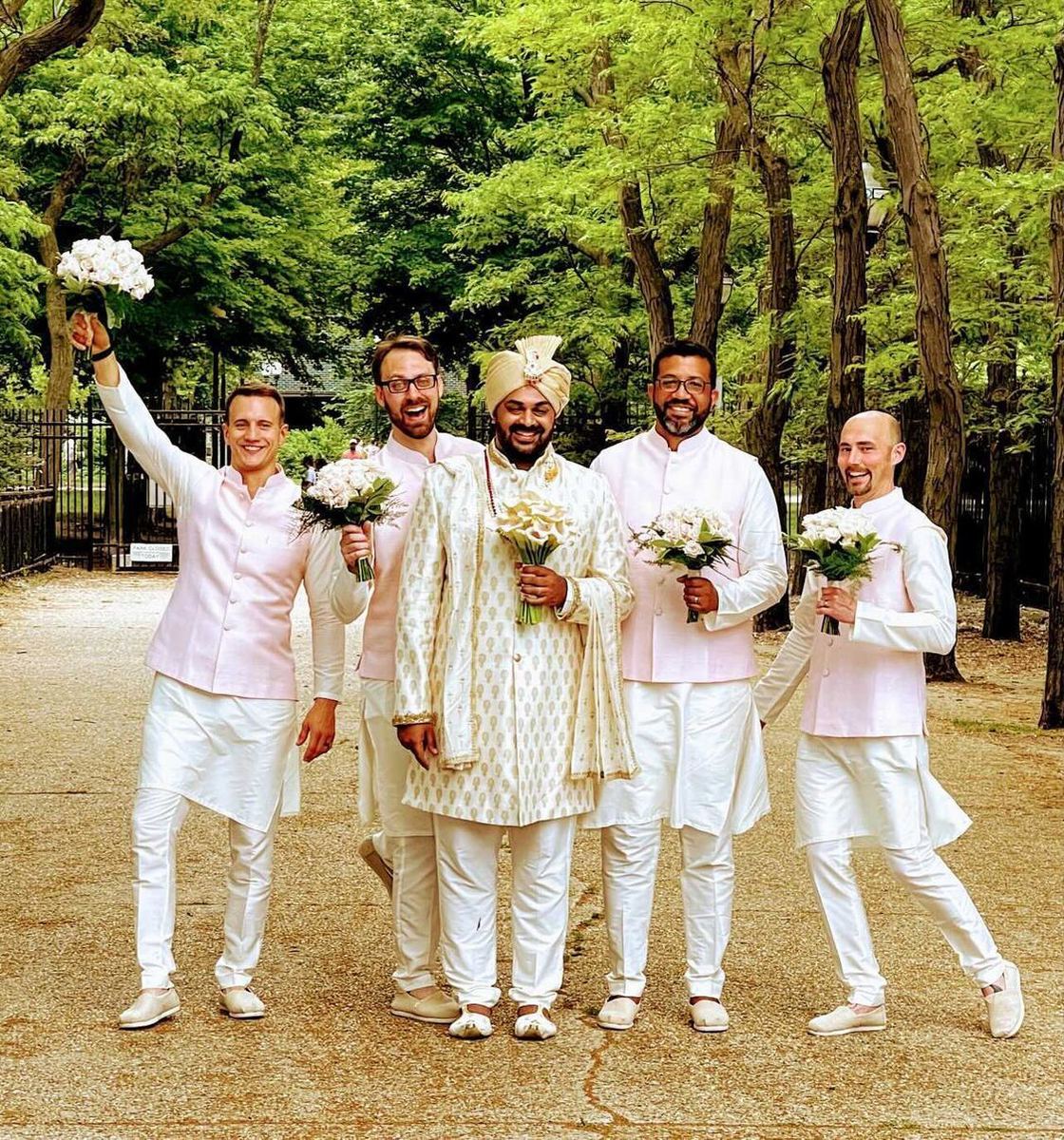 Groom and groomsmen in ivory sherwanis with pink accents