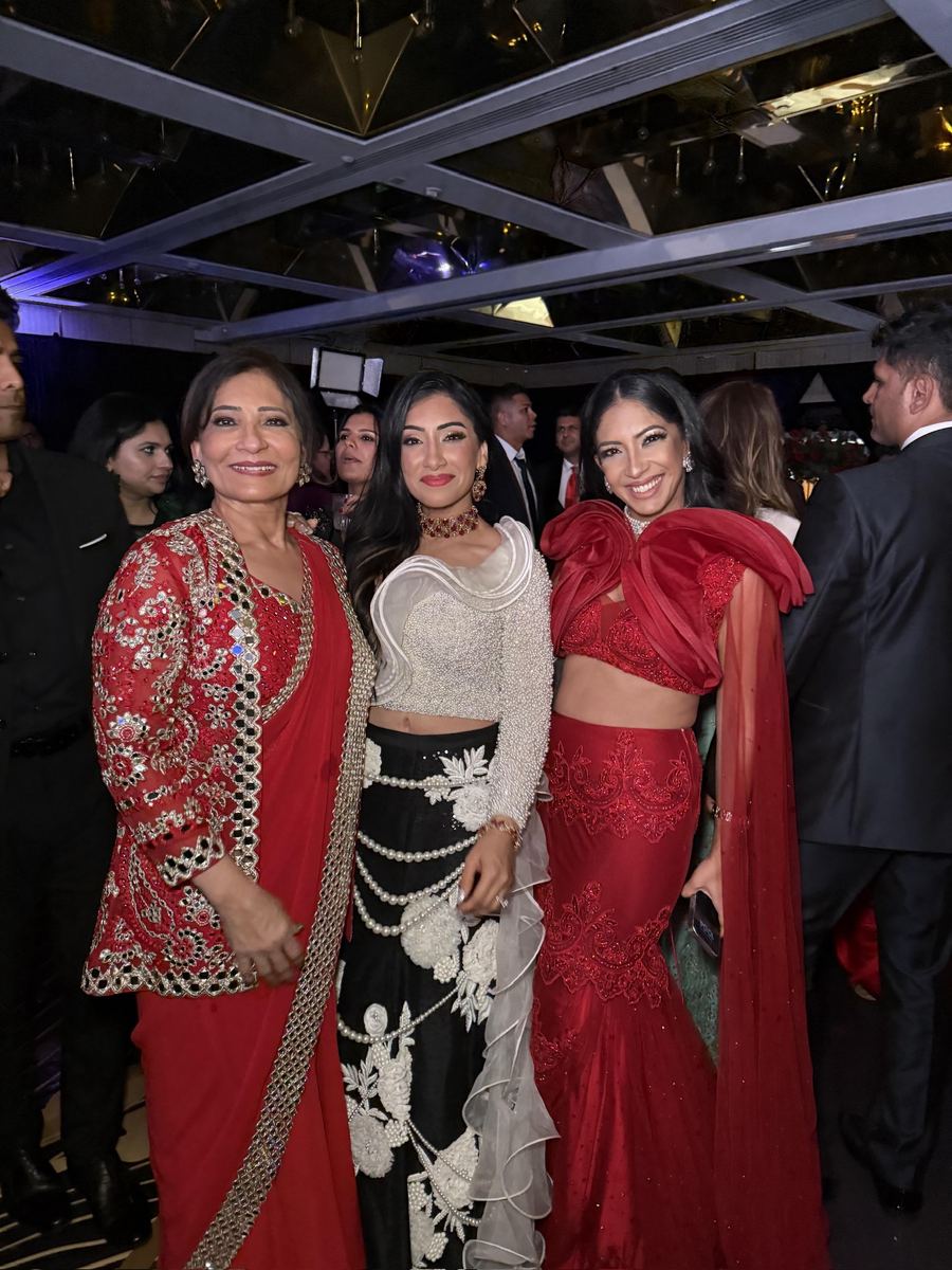Guests styled in red and ivory embellished reception looks