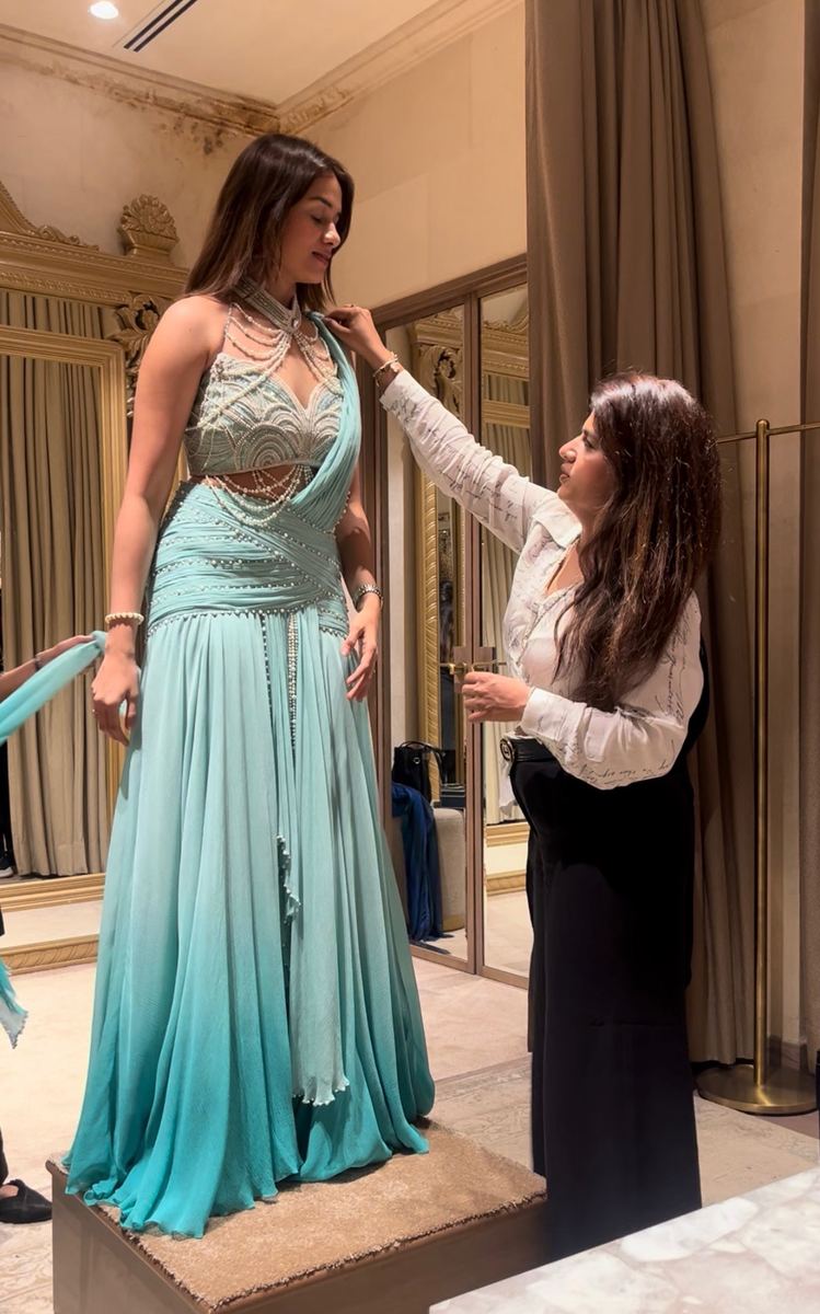 Priya Chhabria fitting a client in a teal embellished gown
